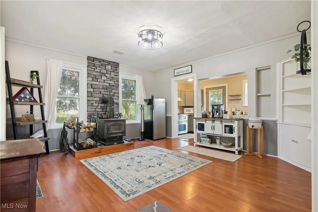 Dining area featuring a wood stove and wood look floors