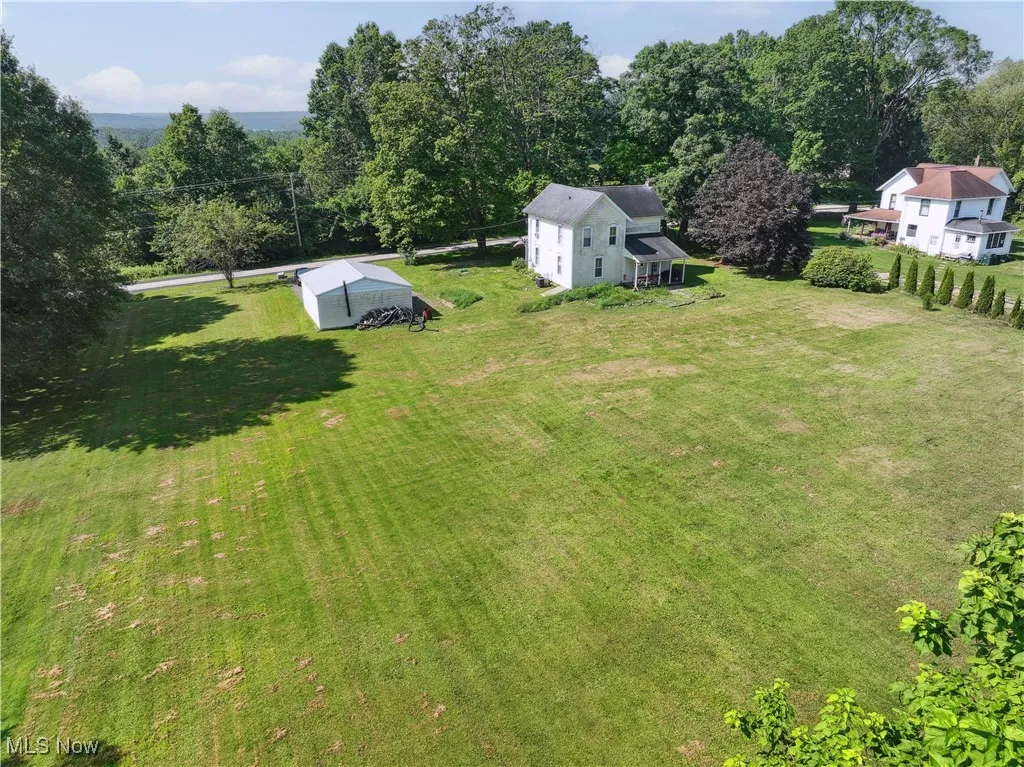 View of grassy yard with an outdoor structure