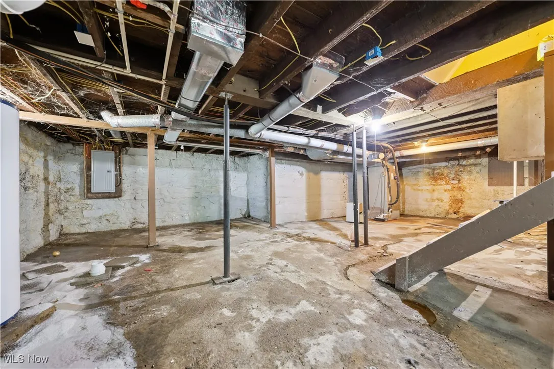 Unfinished basement featuring electric panel