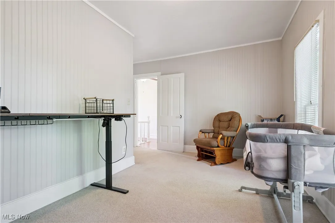 Bedroom featuring carpet flooring and crown molding