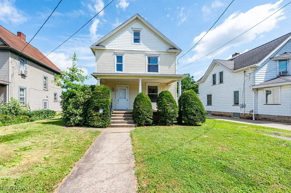 Victorian house with a porch and a front lawn