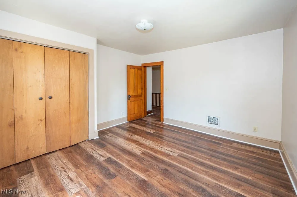 bedroom featuring wood finished floors and a closet