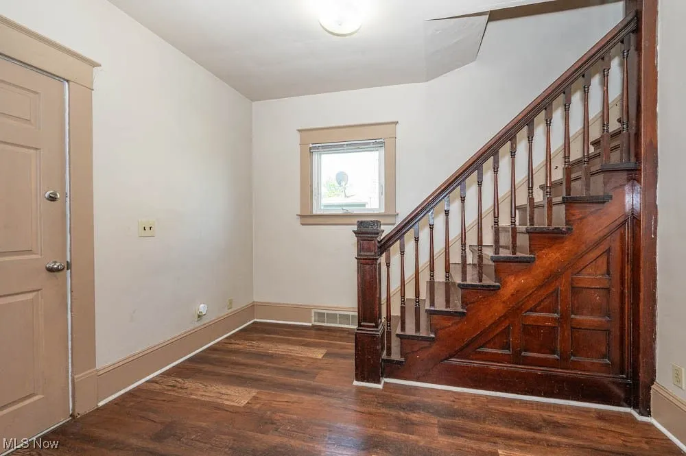 Staircase featuring wood finished floors and baseboards