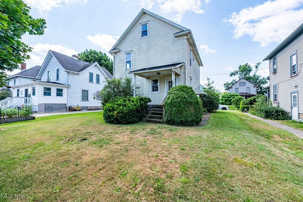 Rear view of property featuring a yard