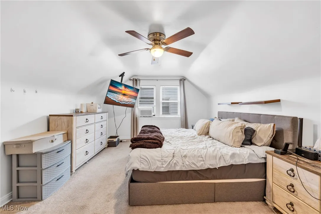 Bedroom with carpet flooring, lofted ceiling, and ceiling fan
