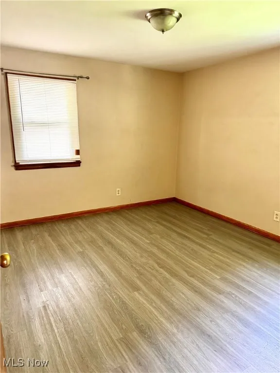 Empty room with wood finished floors and baseboards