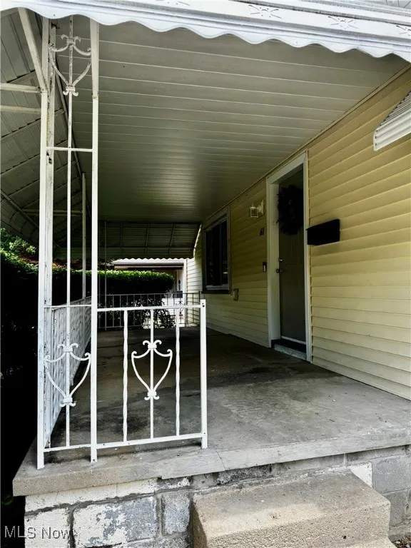 View of exterior entry featuring a carport