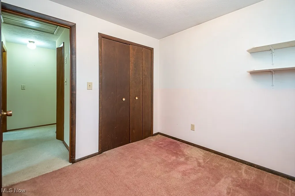 Unfurnished bedroom with carpet flooring and a closet