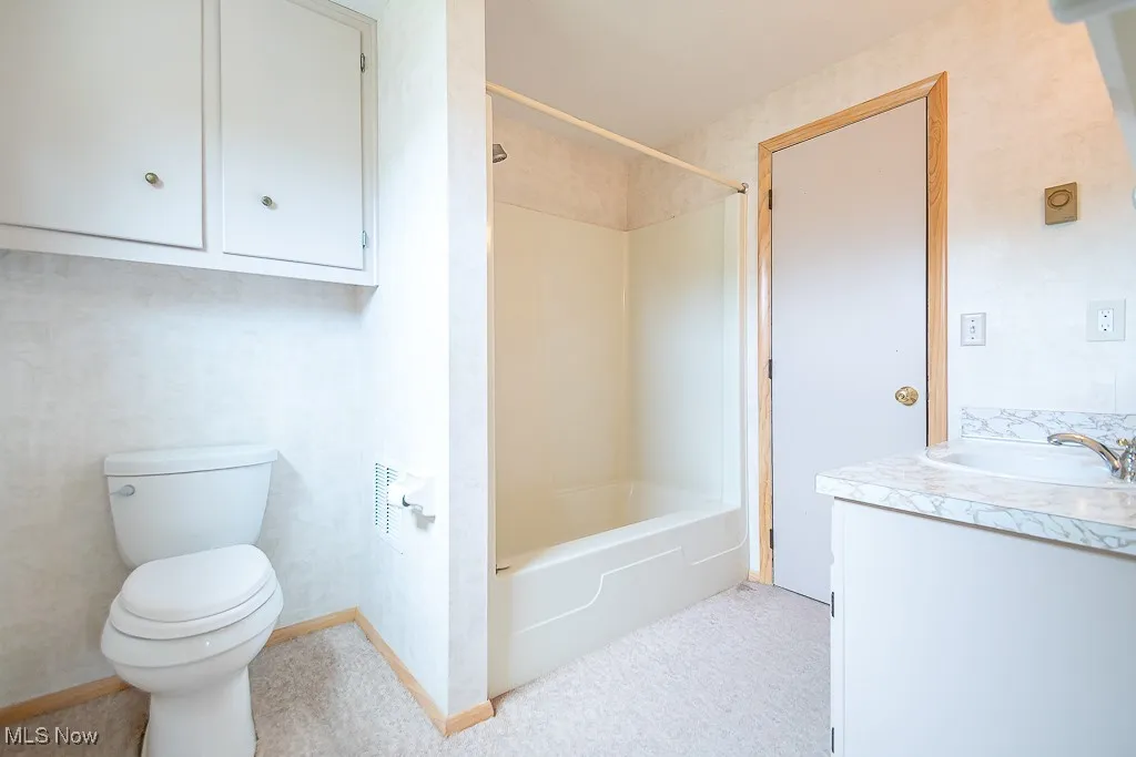 Full bath featuring vanity and bathing tub / shower combination