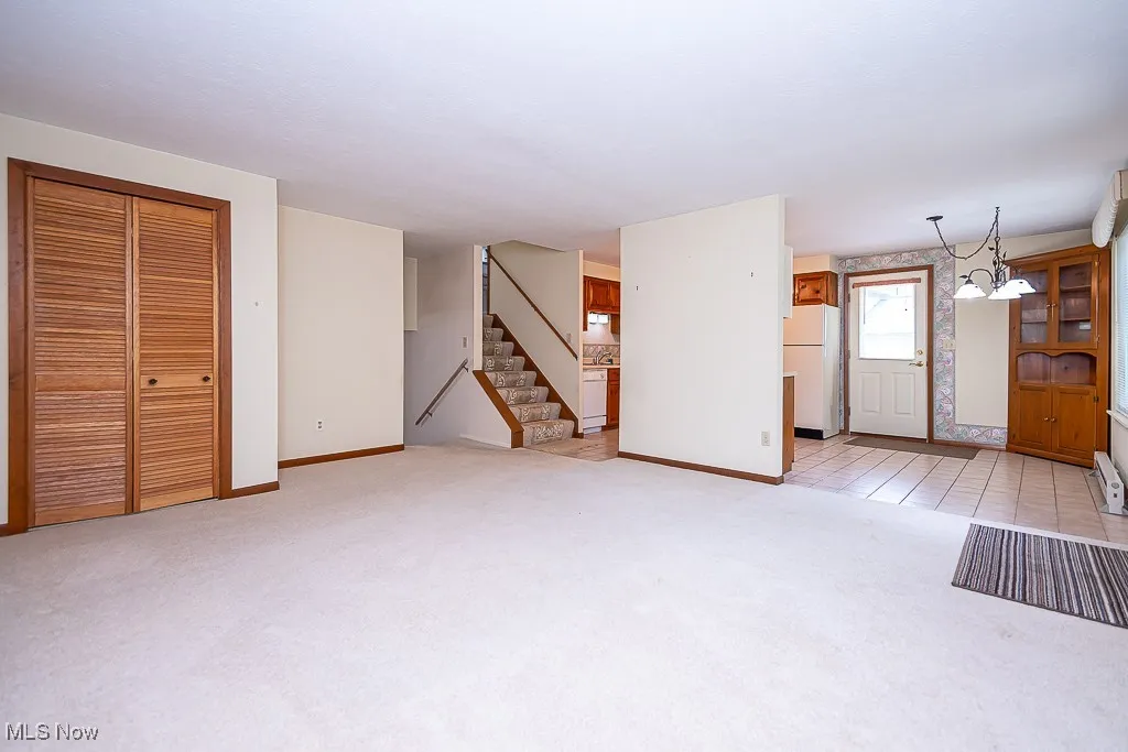 Unfurnished living room with newer carpeting