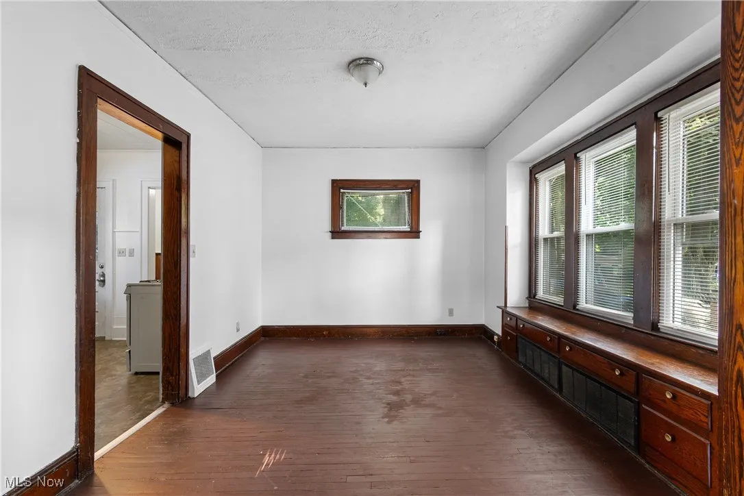 Dining room with built-in cabinets and window seat.