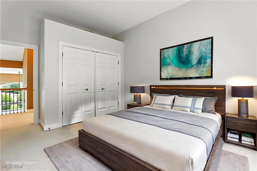 Bedroom with light carpet and a closet