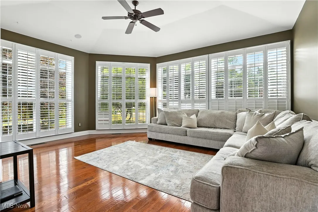 Living room featuring ceiling fan and wood finished floors