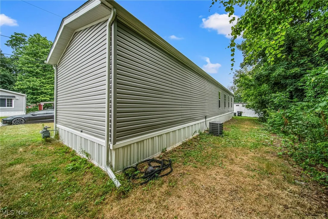 View of property exterior featuring a yard