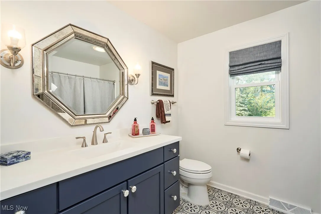 Bathroom with vanity and tile patterned flooring