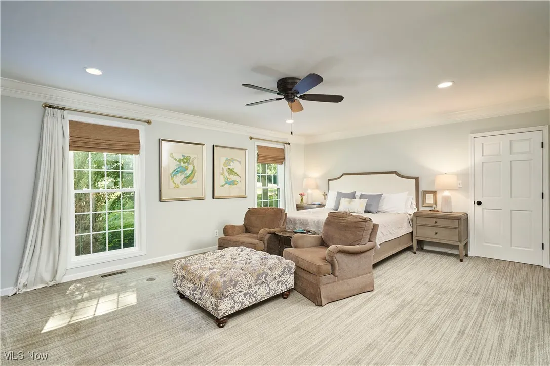 Bedroom featuring light carpet, recessed lighting, ornamental molding, and ceiling fan