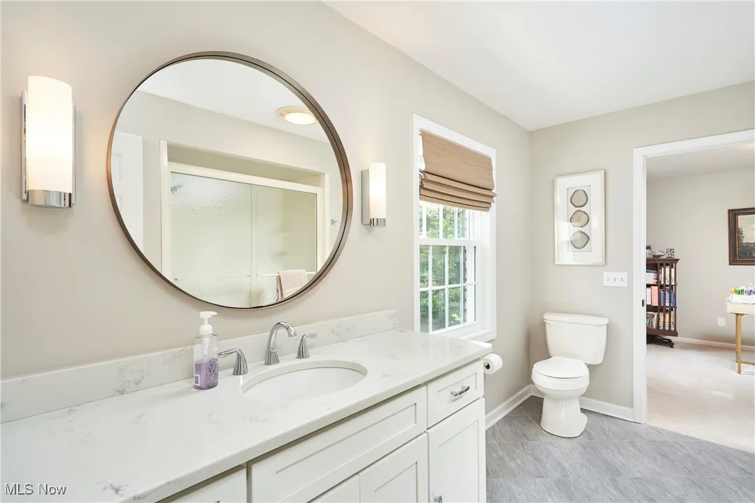 Bathroom featuring vanity and a shower with shower door