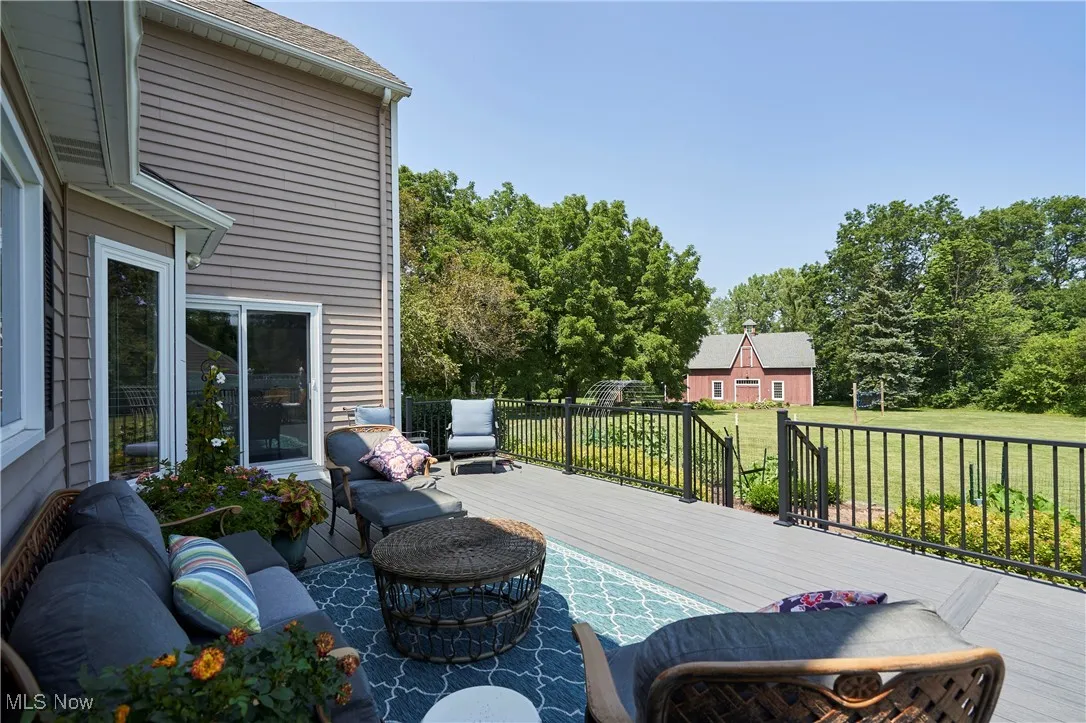 Composite  deck with a lawn and view of barn.