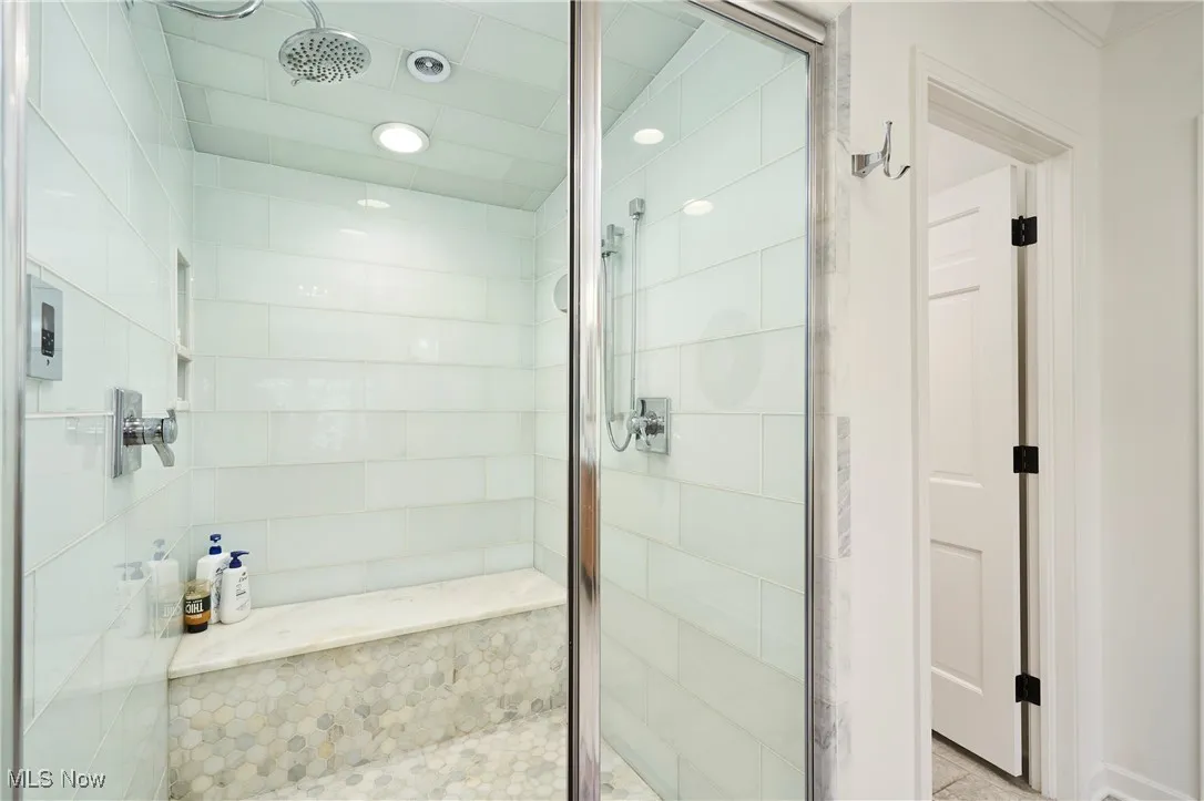 Bathroom featuring a shower stall and recessed lighting
