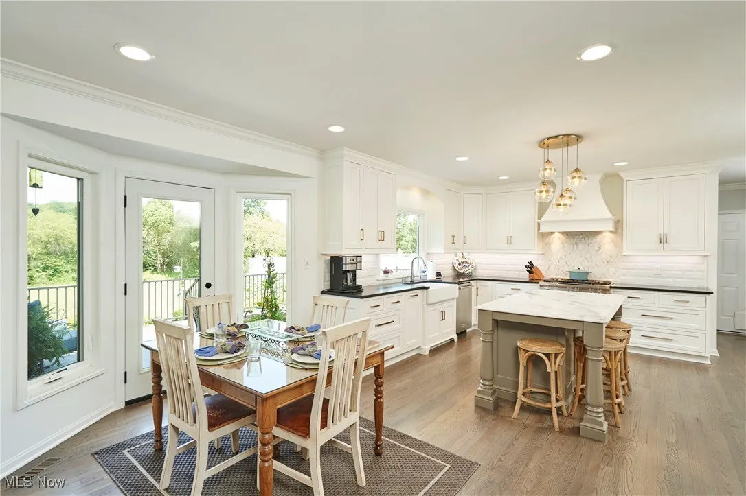 Kitchen with recessed lighting, wood finished floors, and ornamental molding