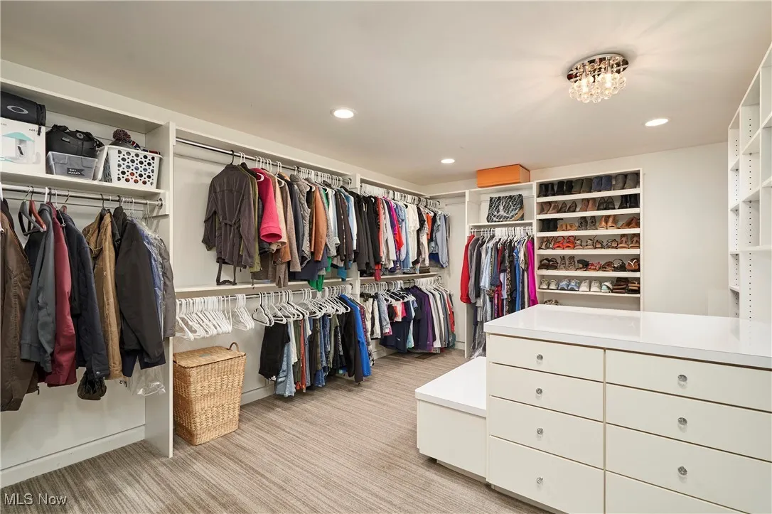 Spacious closet with light colored carpet