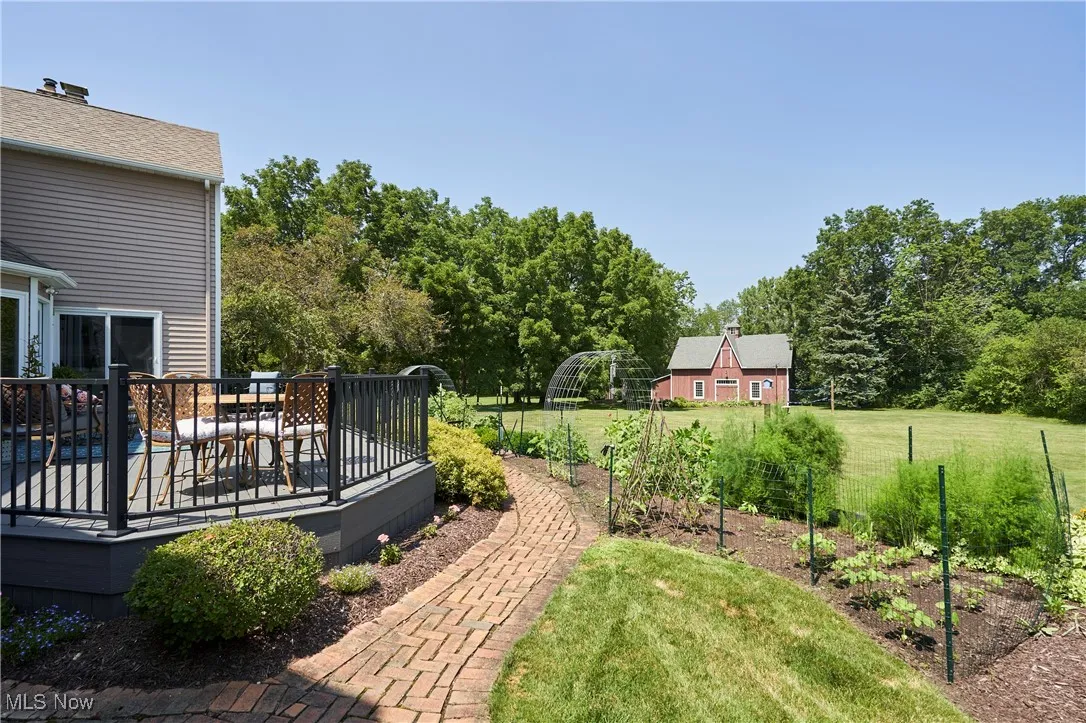View of green lawn featuring a composite
 deck