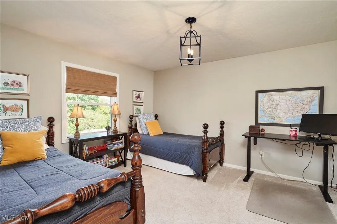 Carpeted bedroom featuring baseboards