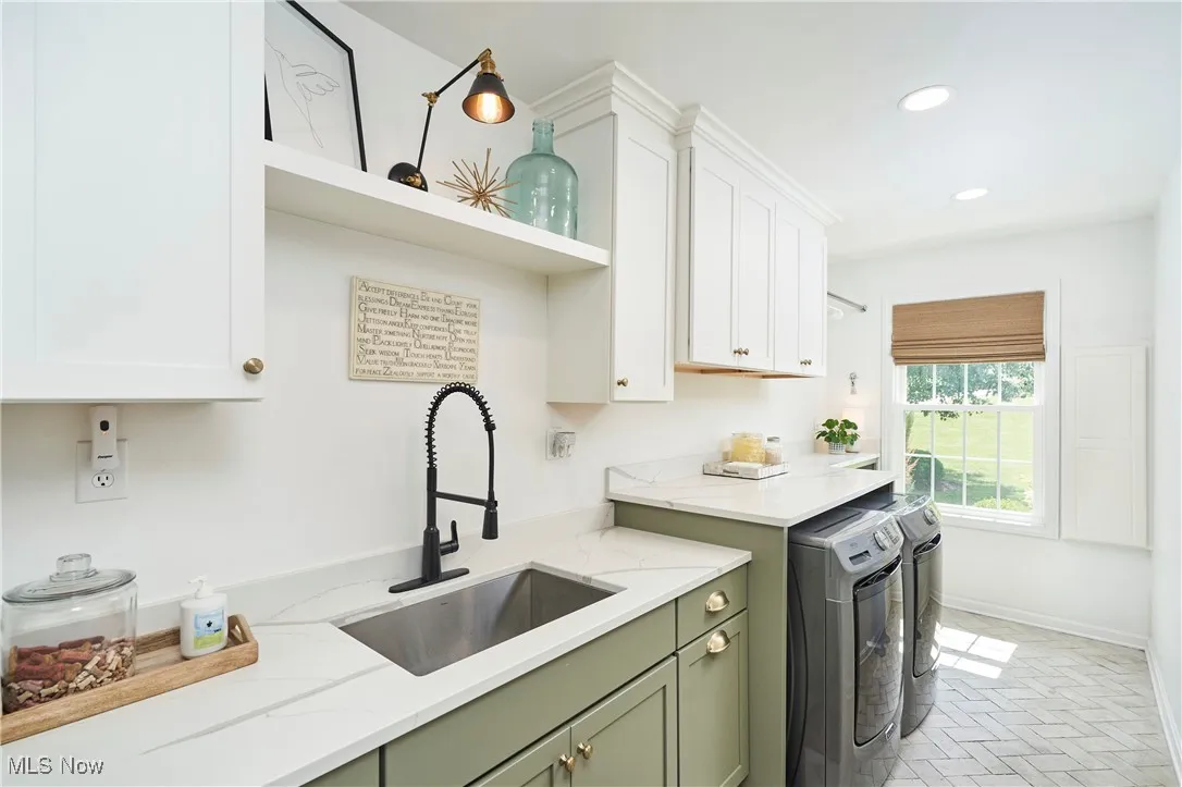 Laundry featuring washing machine and clothes dryer, recessed lighting, open shelves, white cabinets, and light stone counters