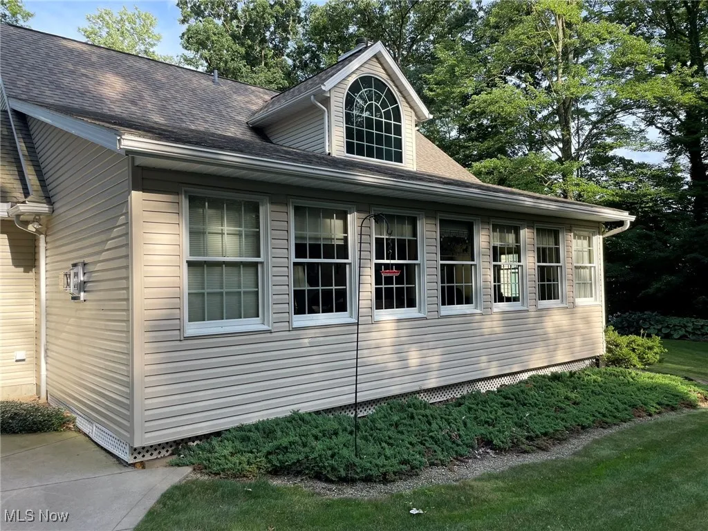 View of home's exterior featuring roof with shingles