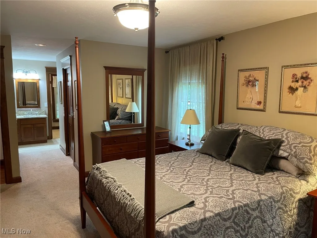 Bedroom with carpet floors and ensuite bathroom