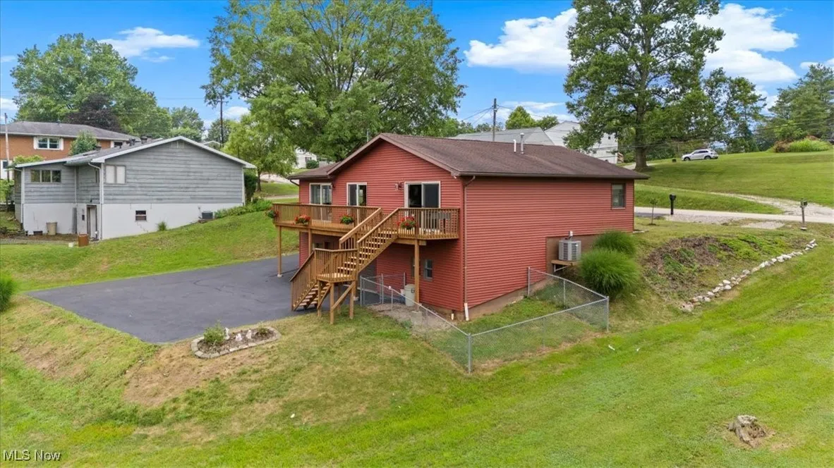 Back of house featuring a deck and stairs