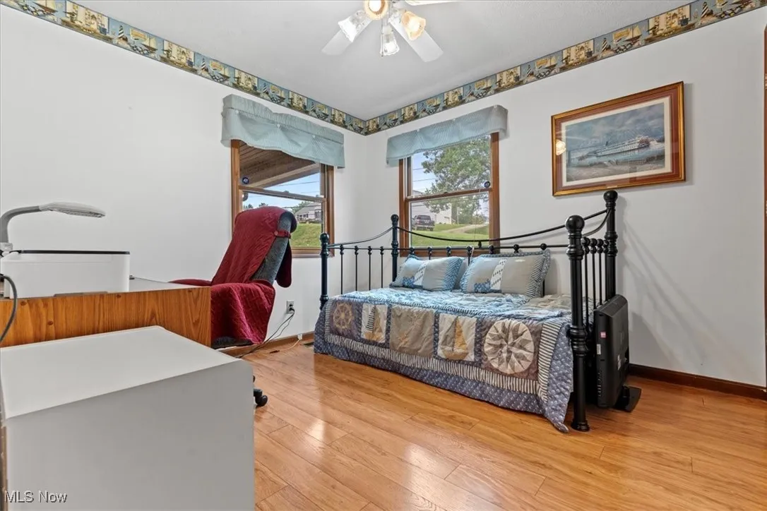 #2 Bedroom featuring light wood-style floors and a ceiling fan and closet.