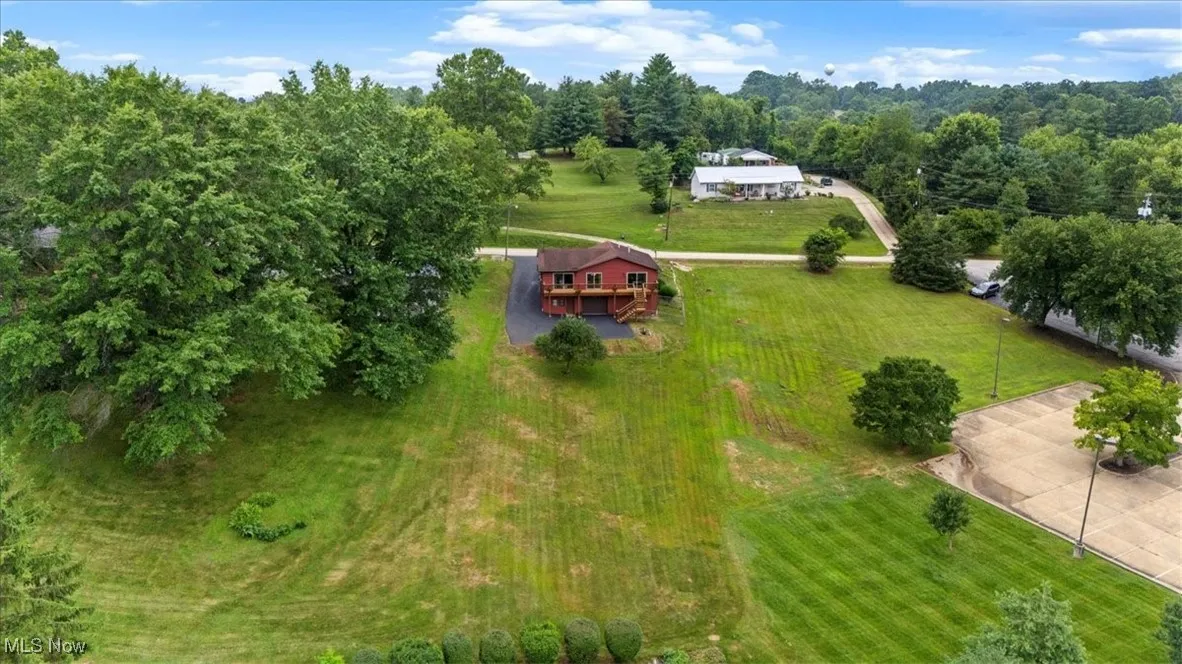 Aerial view of property and surrounding area.  Located Out of City Limits. Lot size is 82.31 x 251.42 x 49.84 x 255.06.  Its features a delicious red apple tree.
