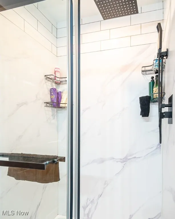 Bathroom with a marble finish shower