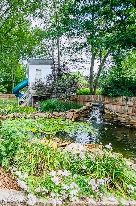 View of yard with a garden pond