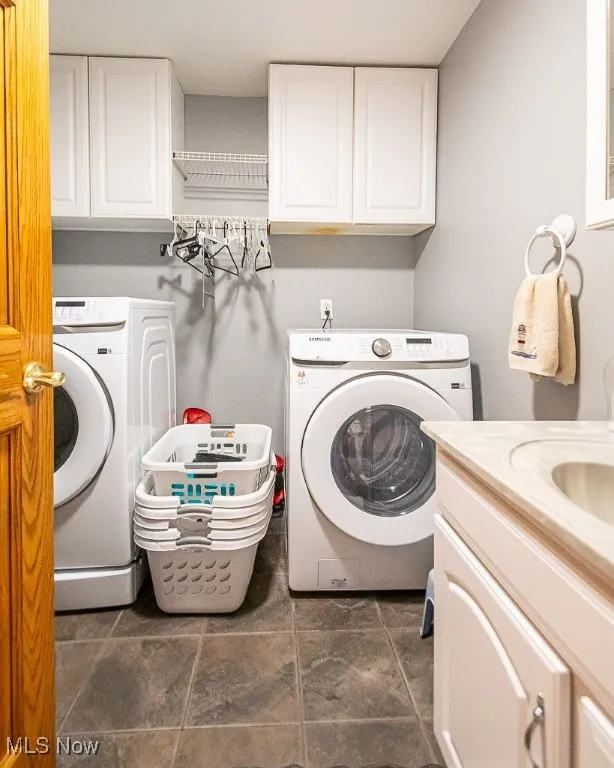 First-floor laundry area with cabinet space, half bath and washer and dryer