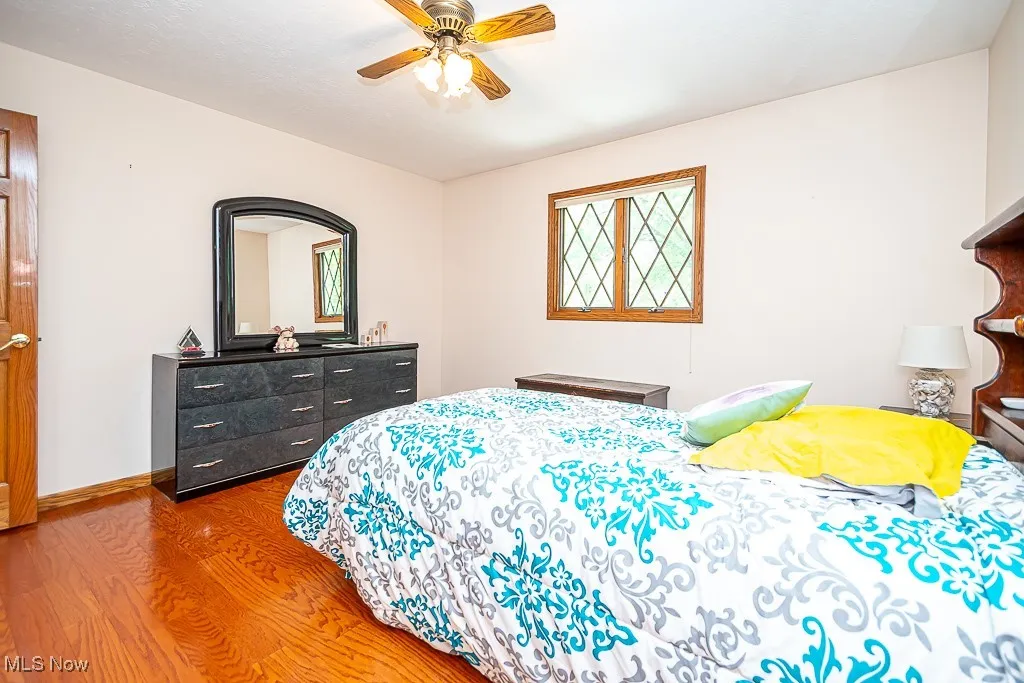 Bedroom featuring wood finished floors and ceiling fan