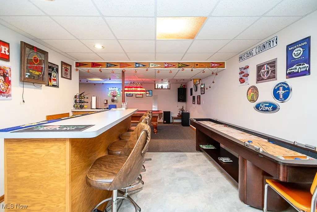 Indoor dry bar with a paneled ceiling