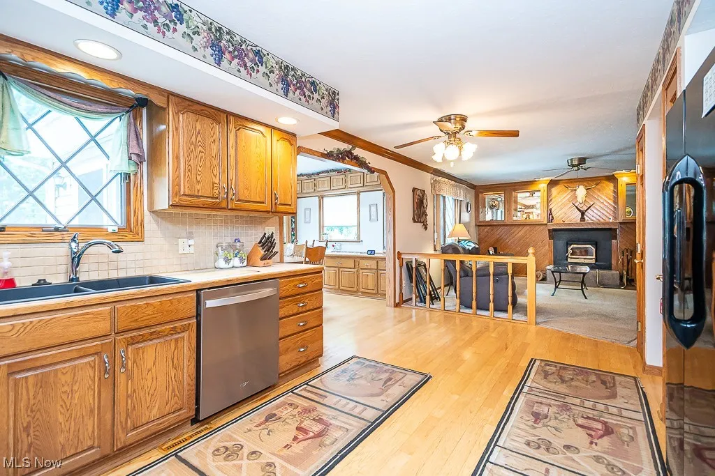 Kitchen featuring stainless steel dishwasher, ceiling fan
