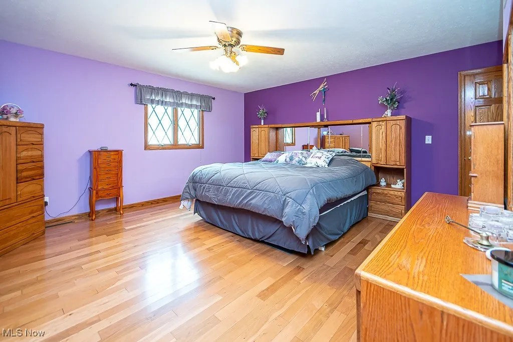 Bedroom featuring light wood floors and a ceiling fan