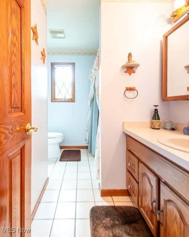 Bathroom with vanity and tile patterned flooring