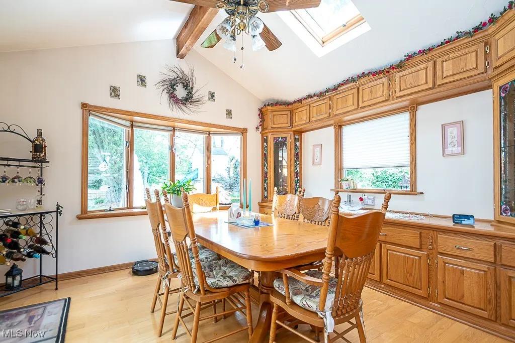 Morning room with ceiling fan, light hardwood flooring, and a skylight