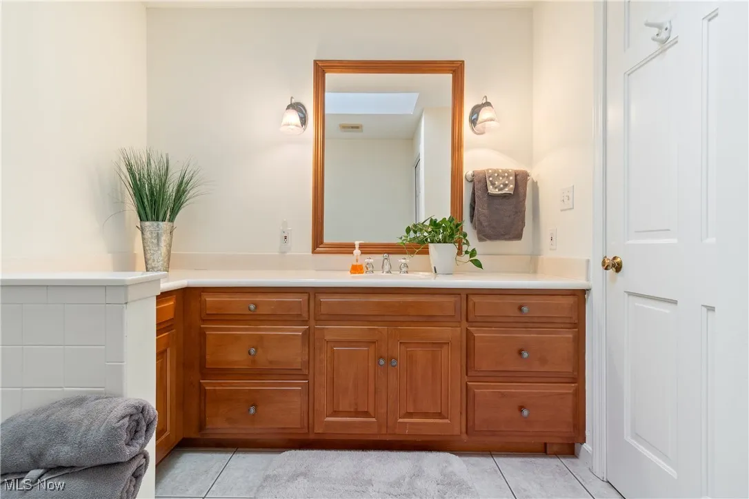Bathroom with vanity and tile patterned floors