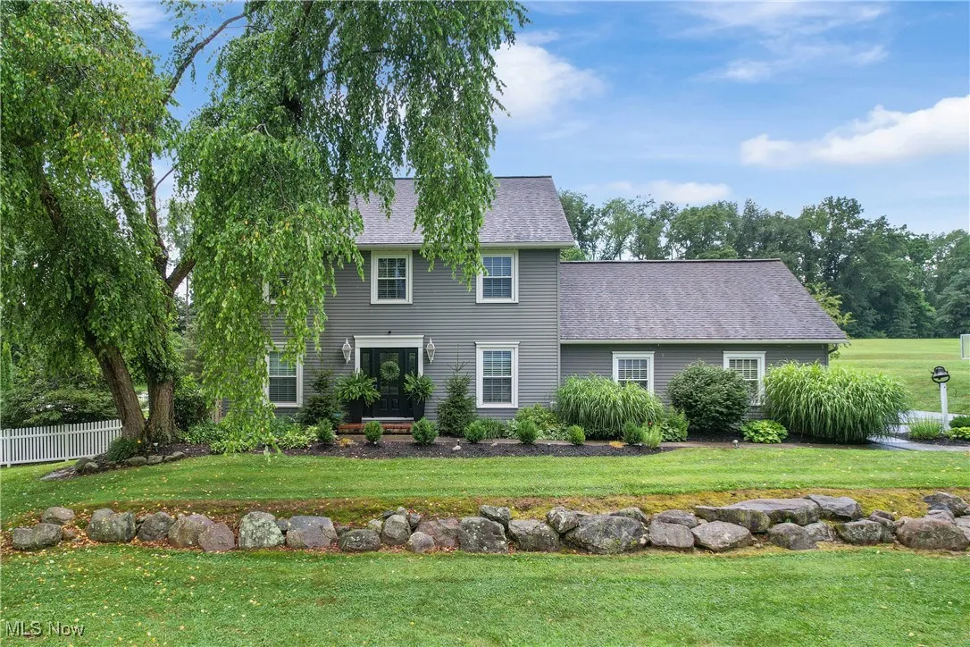 View of front of house with a shingled roof