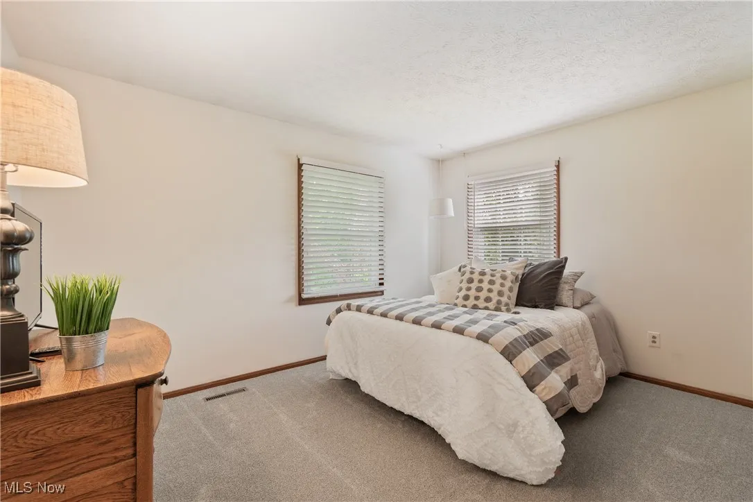 Bedroom featuring carpet floors and baseboards