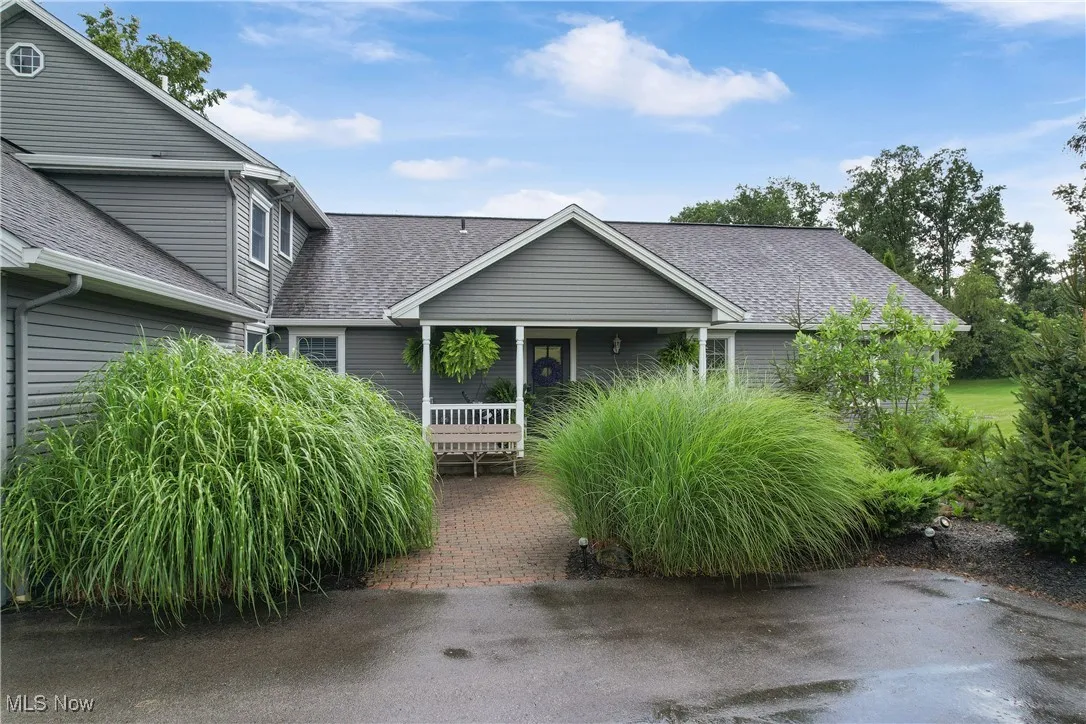 View of front of home with a shingled roof