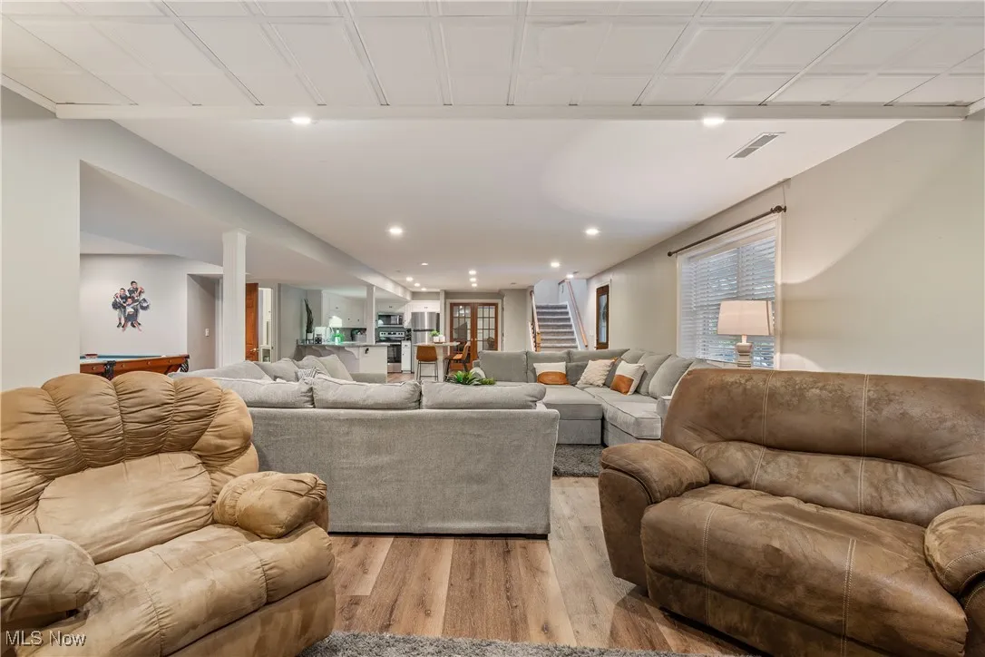Living room featuring light wood-style floors, billiards table, and recessed lighting