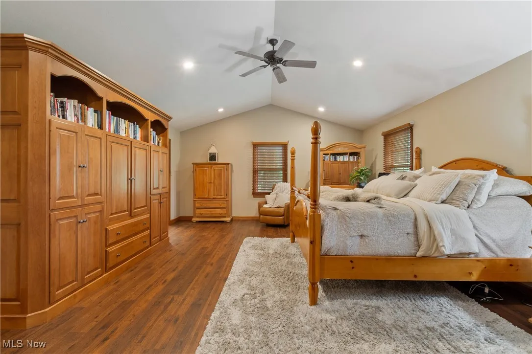 Bedroom featuring lofted ceiling, dark wood finished floors, and recessed lighting