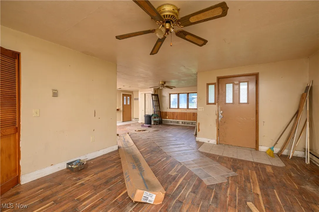 Entrance foyer featuring ceiling fan and wood finished floors