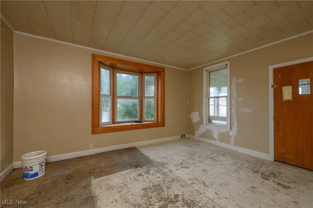 Entrance foyer featuring ornamental molding and baseboards